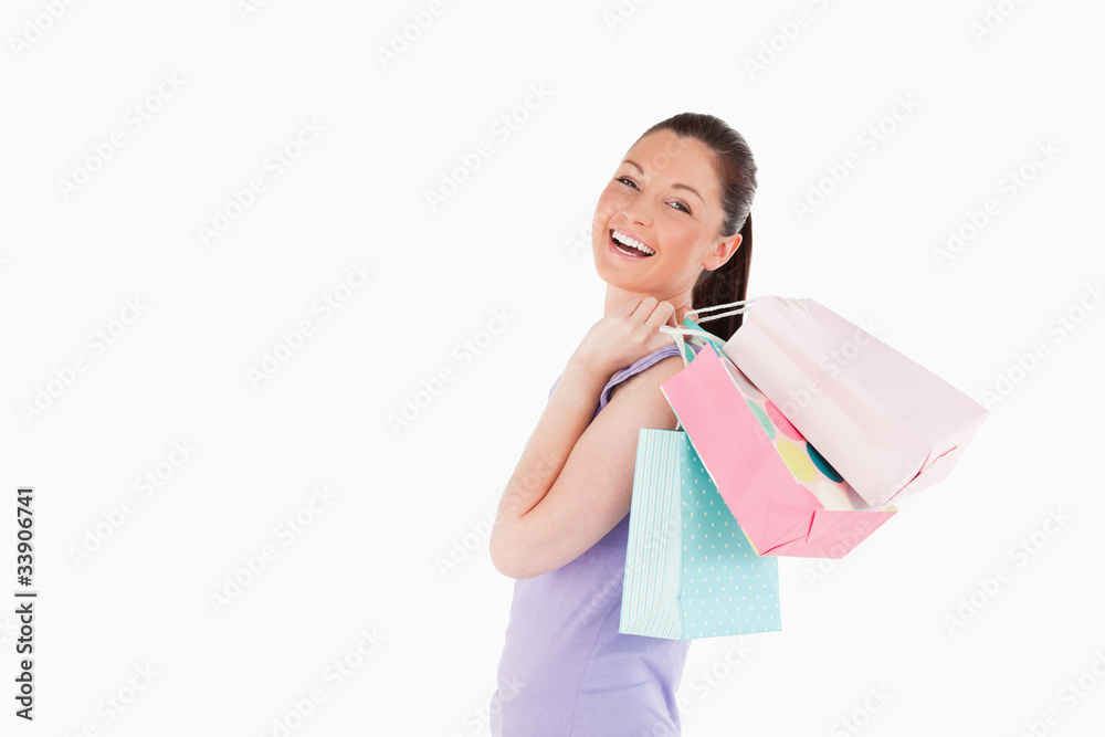 Beautiful woman holding shopping bags while standing Beautiful woman holding shopping bags while standing