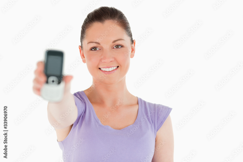 Good looking woman holding and showing her phone while standing Good looking woman holding and showing her phone while standing