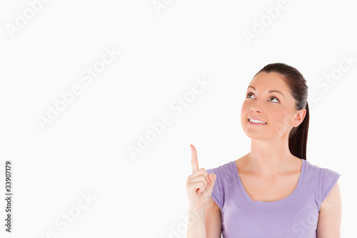 Cute woman pointing at a copy space