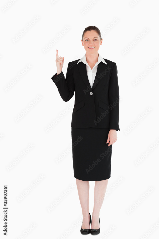Good looking female in suit pointing at a copy space Good looking female in suit pointing at a copy space