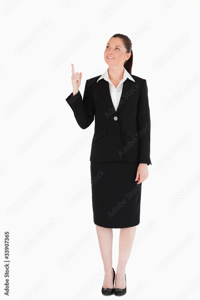 Attractive female in suit pointing at a copy space Attractive female in suit pointing at a copy space