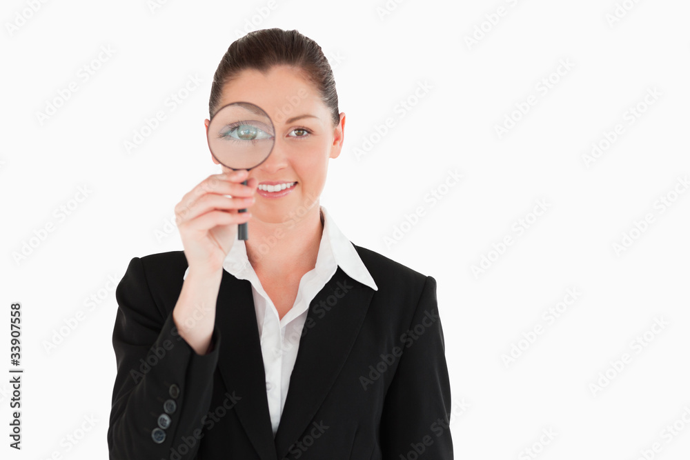 Charming woman in suit holding a magnifying glass Charming woman in suit holding a magnifying glass