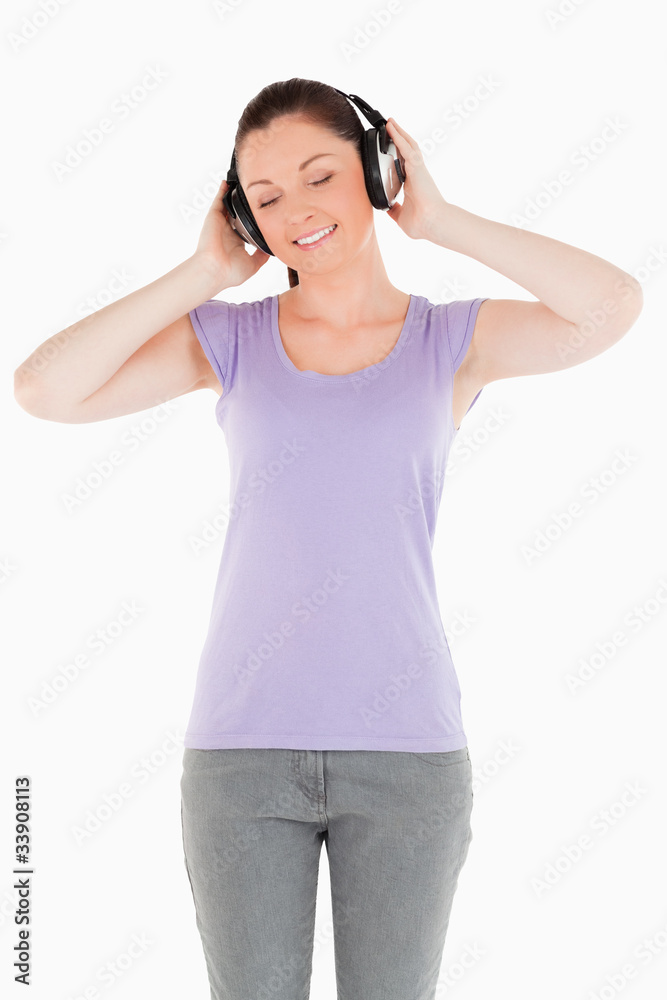 Gorgeous woman posing with headphones while standing Gorgeous woman posing with headphones while standing