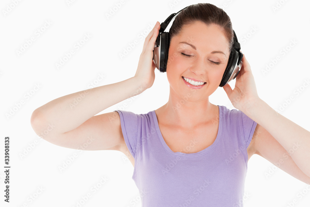 Lovely woman posing with headphones while standing Lovely woman posing with headphones while standing