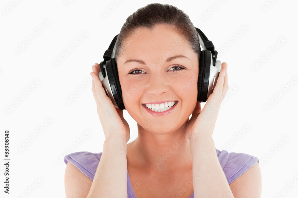 Portrait of a good looking woman posing with headphones while st Portrait of a good looking woman posing with headphones while st