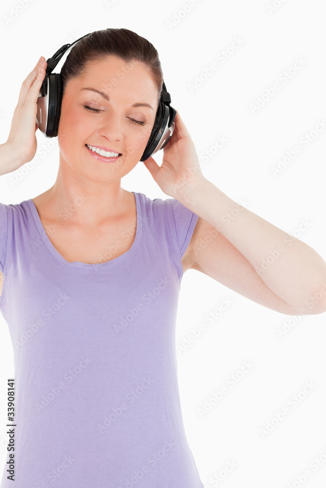 Good looking female posing with headphones while standing Good looking female posing with headphones while standing