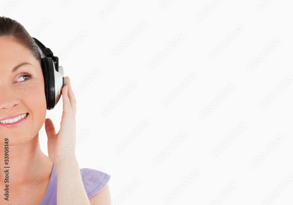Portrait of a charming woman posing with headphones while standi Portrait of a charming woman posing with headphones while standi