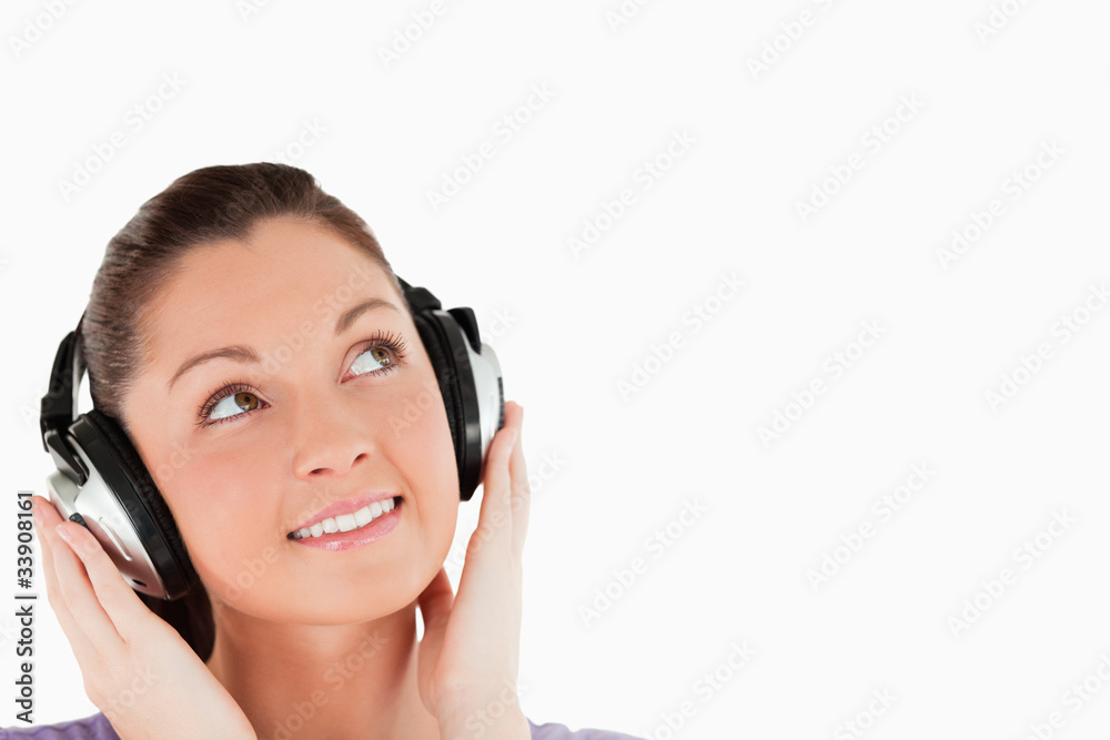 Portrait of a lovely woman posing with headphones while standing Portrait of a lovely woman posing with headphones while standing
