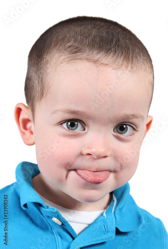 Cute little boy posing for camera on white background