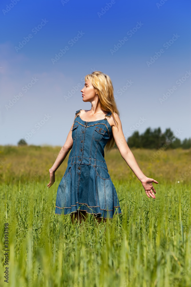 The happy young woman in the field of green ears The happy young woman in the field of green ears