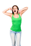 Woman in green top yawning and stretching herself