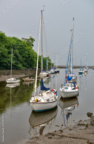 Boats moored at mouth of River Almond, Cramond, Scotland, UK