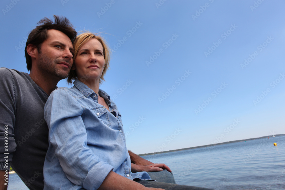 Couple sat by water