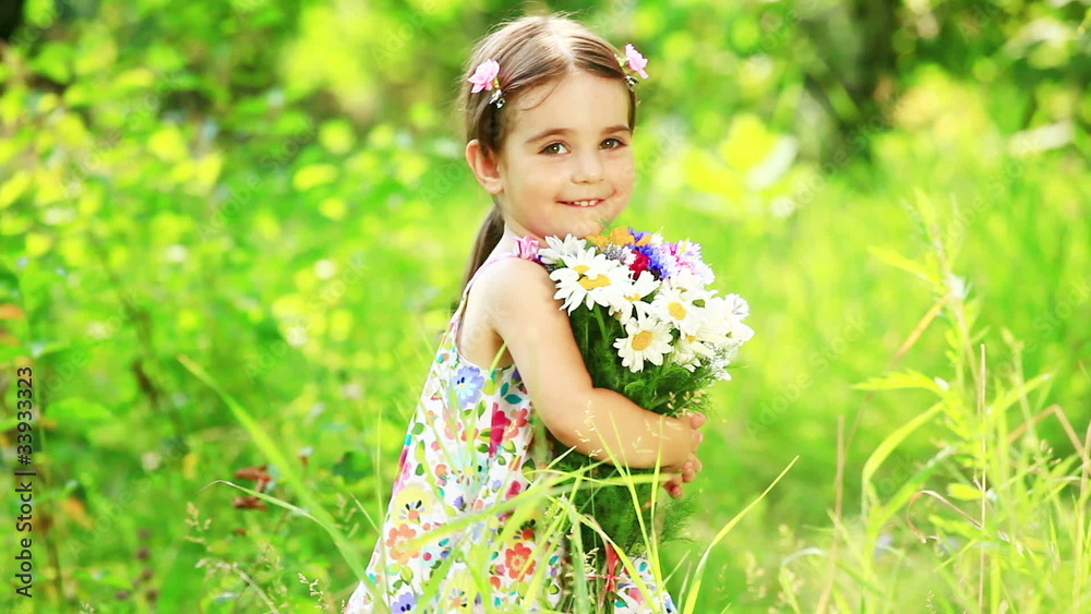 Girl turning with flowers in the grass Girl turning with flowers in the grass