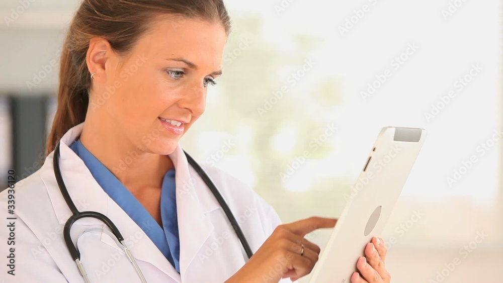 Female doctor using a tablet computer Female doctor using a tablet computer