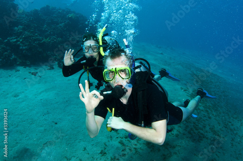 scuba divers make OK sign