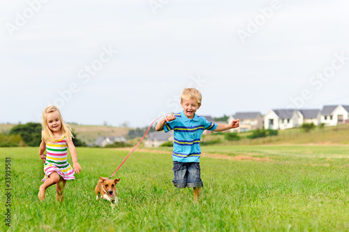Cute blond kids running in a field