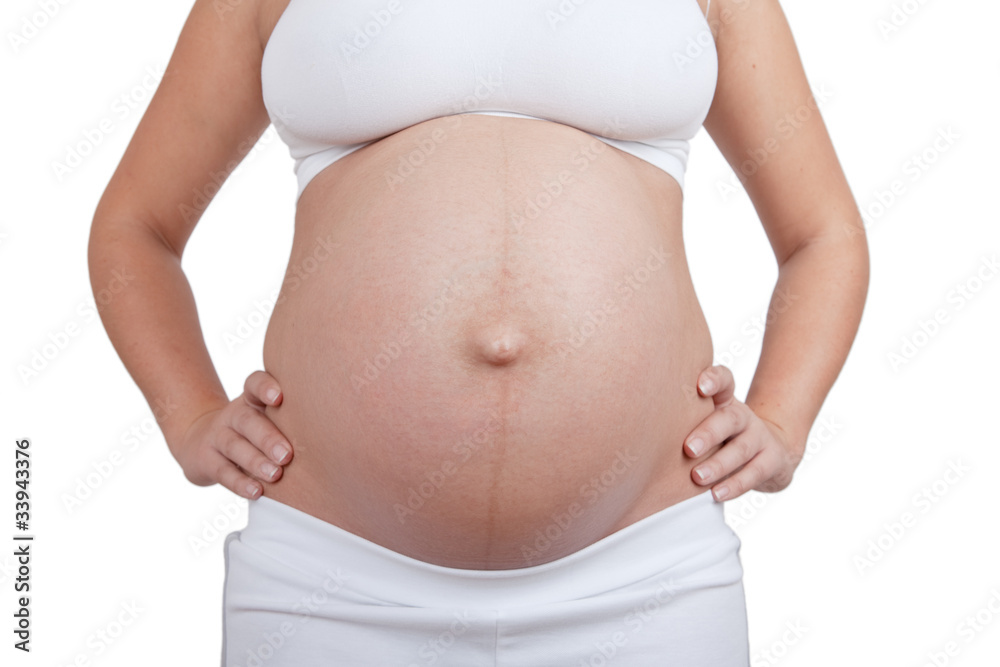 Pregnant woman hold hands on a side of belly Pregnant woman hold hands on a side of belly
