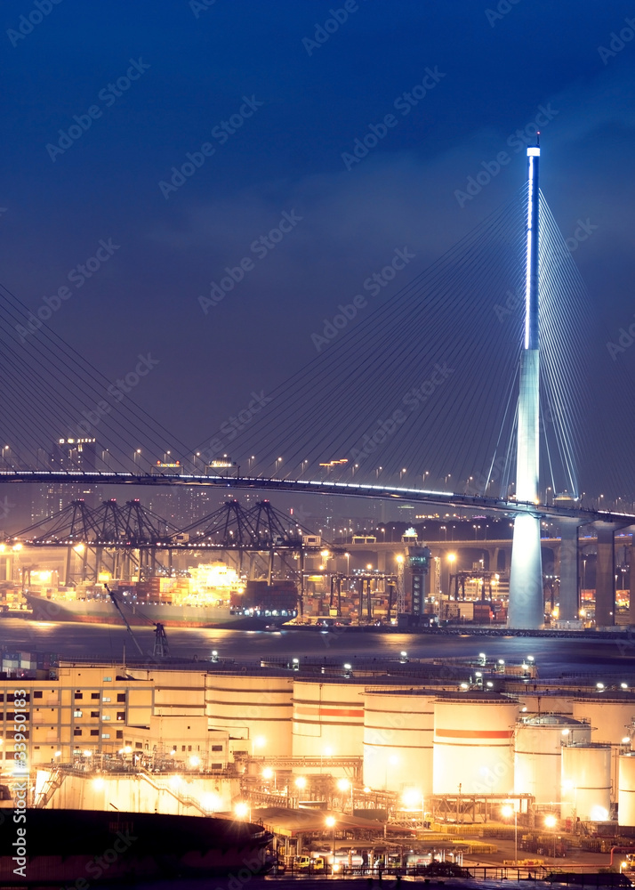 gas container and bridge at night