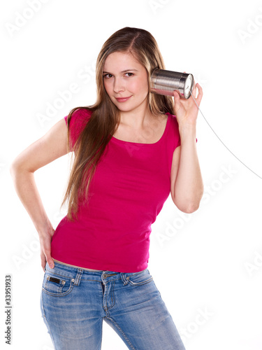 Young woman listening to a tin phone / can phone