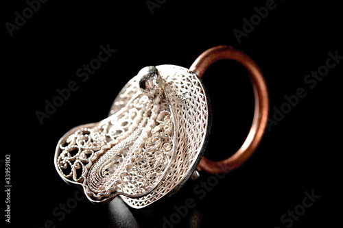 Silver stylish ring on black background