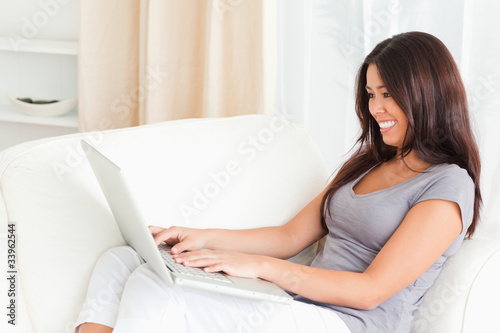 working lady with notebook on sofa
