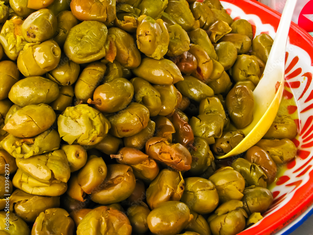 many fermented olives in colorful dish many fermented olives in colorful dish