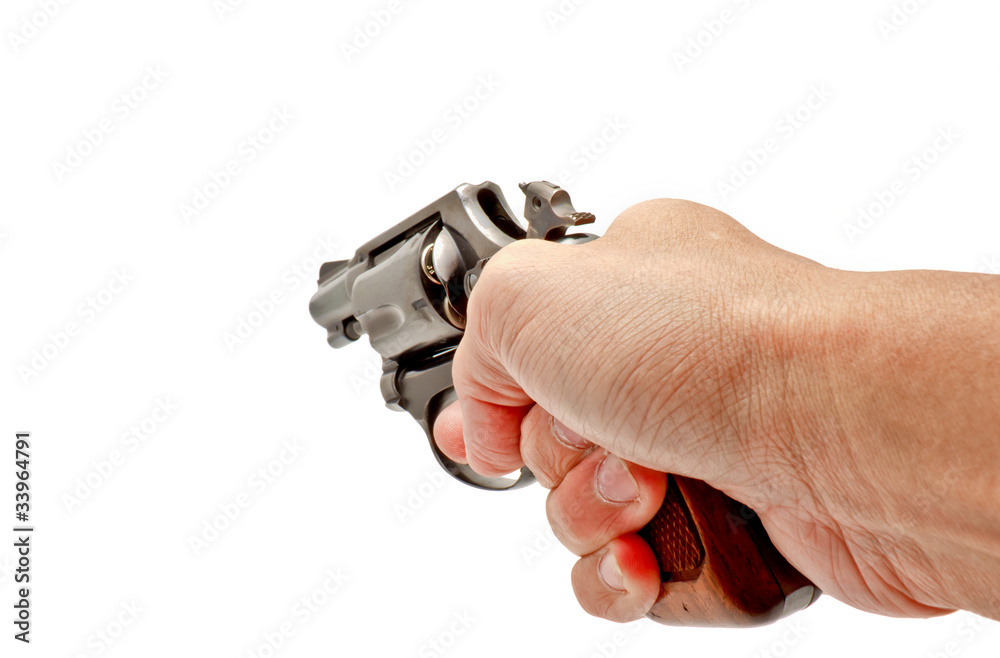 A hand holding a revolver handgun aiming toward A hand holding a revolver handgun aiming toward