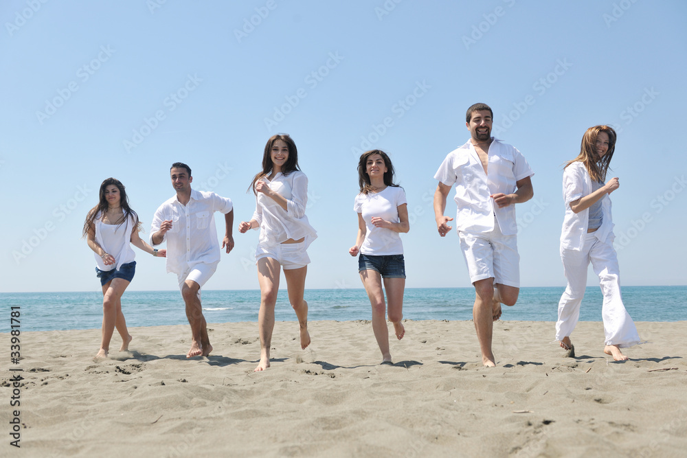 happy people group have fun and running on beach