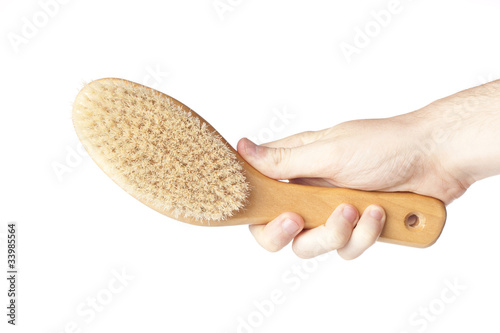 A brown woodem hairbrush