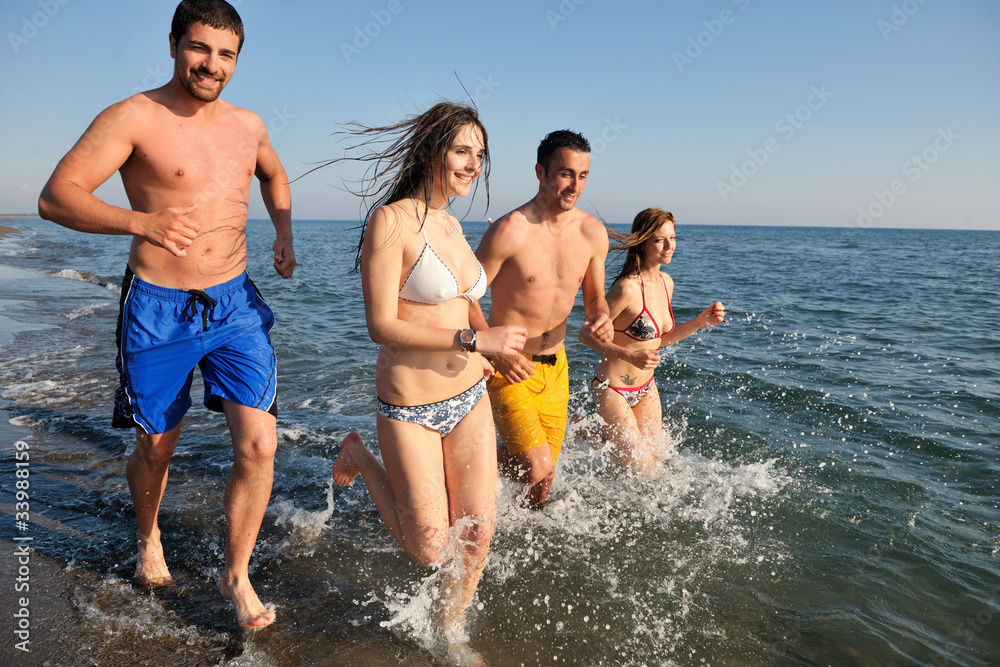 happy people group have fun and running on beach