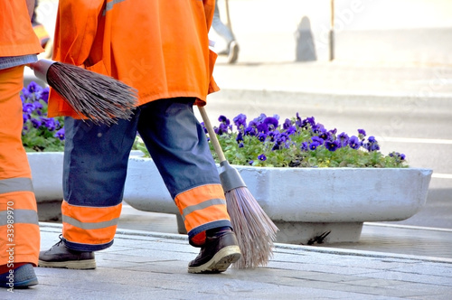 Street cleaners infront of flowers
