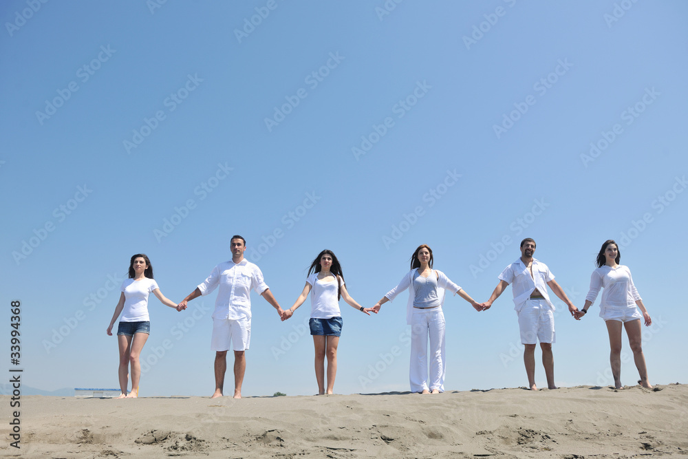 Naklejka premium happy people group have fun and running on beach