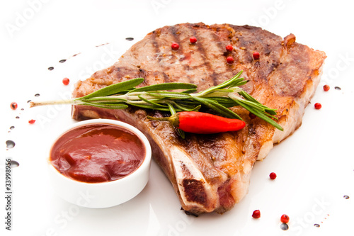 Closeup of grilled steak with peper corns and rosemary