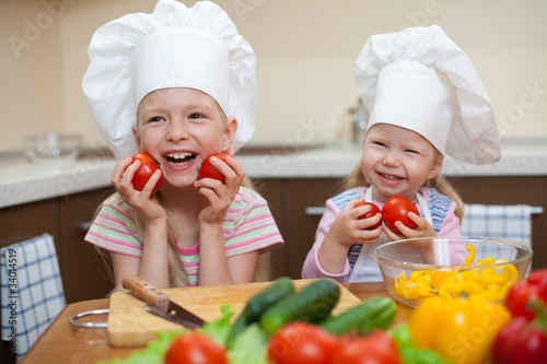 two little girls preparing healthy food on kitchen