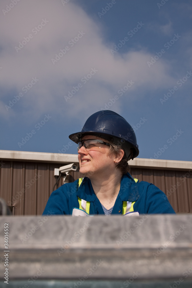 Portrait of a lady construction worker wearing a hard hat Portrait of a lady construction worker wearing a hard hat