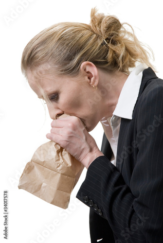 woman breathing into a brown paper bag