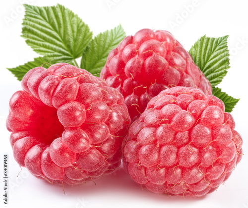 Three perfect ripe raspberries with leaves.