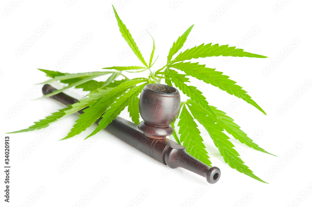 Cannabis sativa. Marijuana leaf and smoking pipe Stock Photo