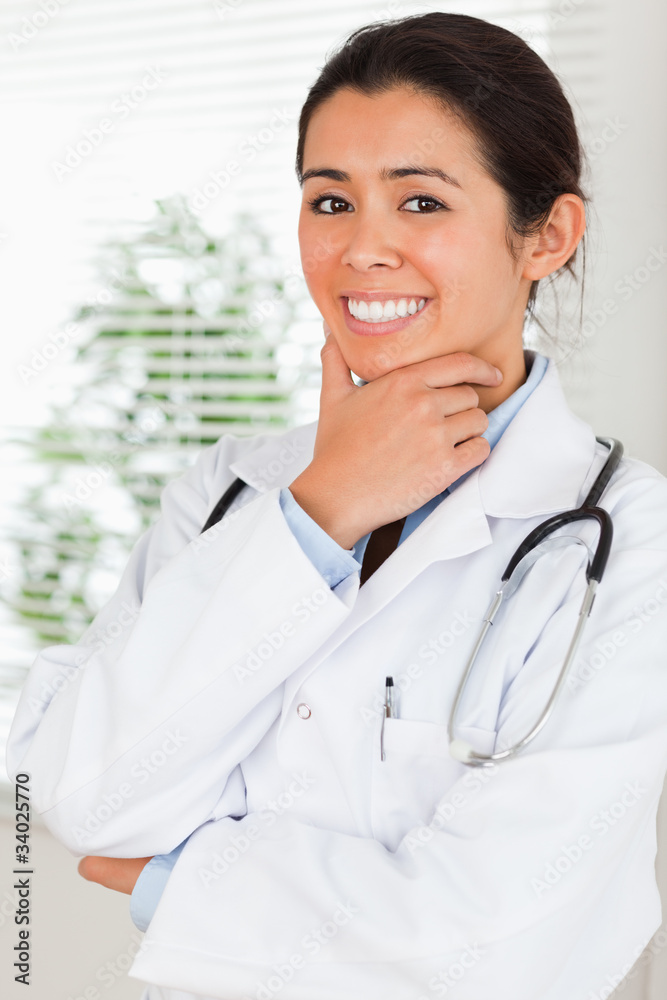 Beautiful female doctor with a stethoscope posing while standing Beautiful female doctor with a stethoscope posing while standing
