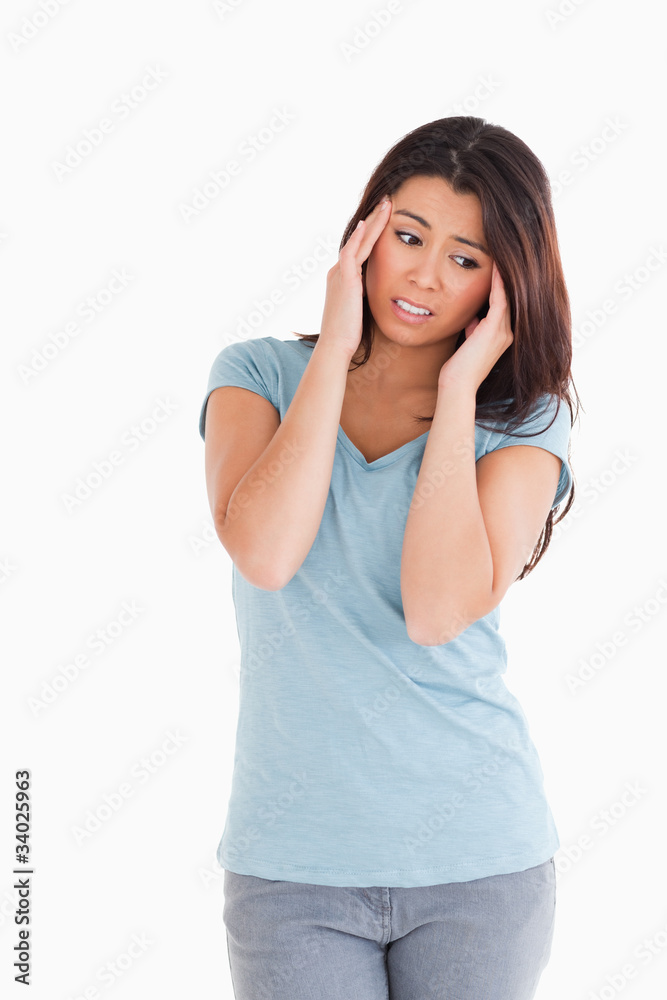 Attractive woman having a headache while standing Attractive woman having a headache while standing