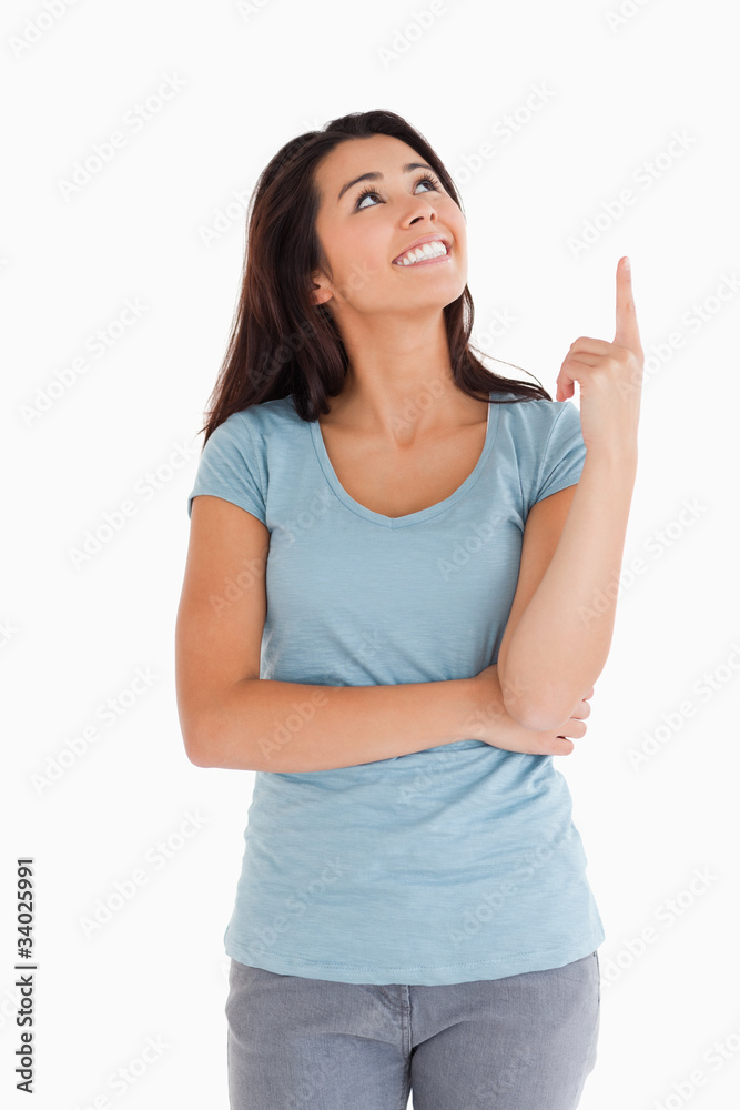 Pretty woman showing a copy space with her finger while standing Pretty woman showing a copy space with her finger while standing