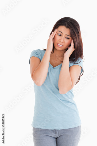 Attractive woman having a headache while standing © WavebreakmediaMicro