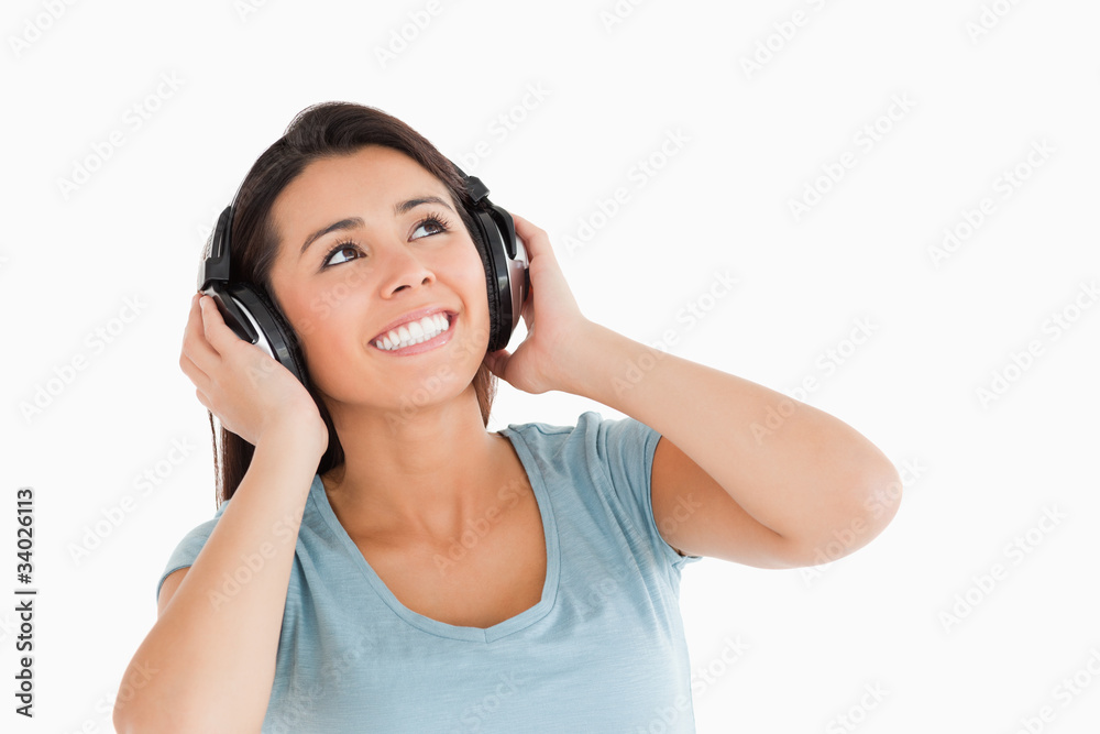 Beautiful woman with headphones looking at something Beautiful woman with headphones looking at something
