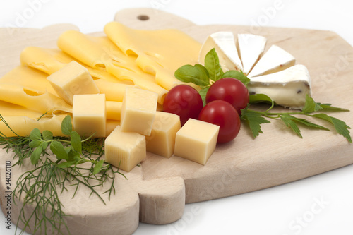 Various types of cheese on a wooden board