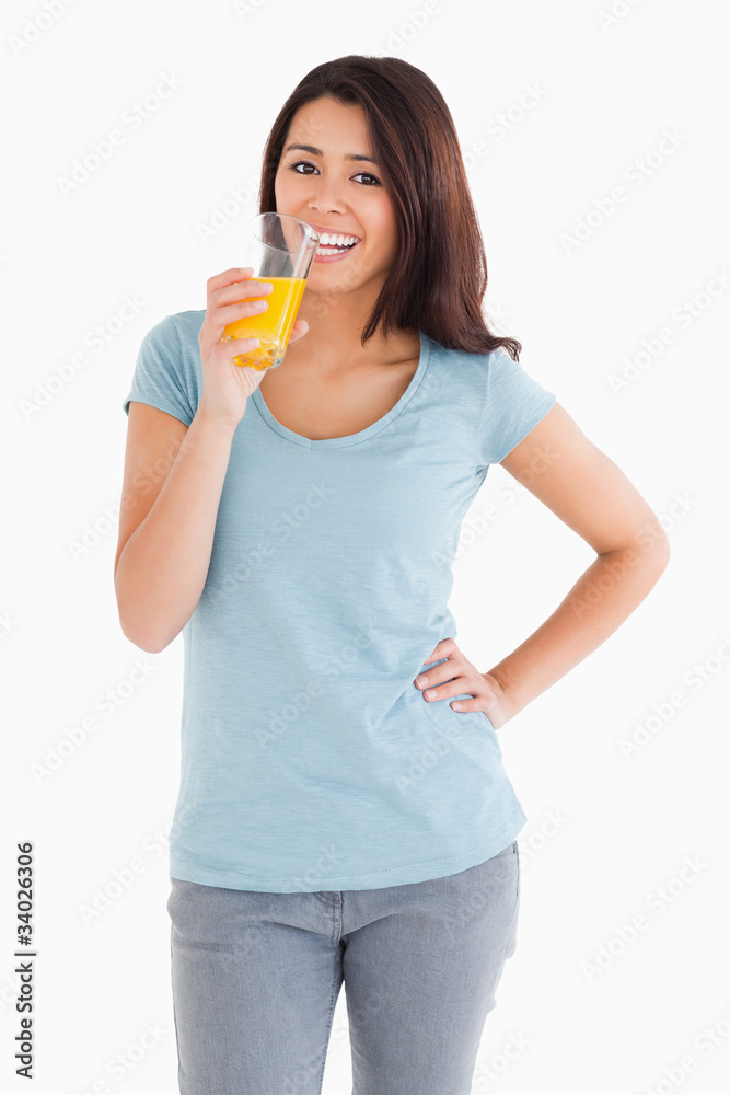 Gorgeous woman drinking a glass of orange juice Gorgeous woman drinking a glass of orange juice
