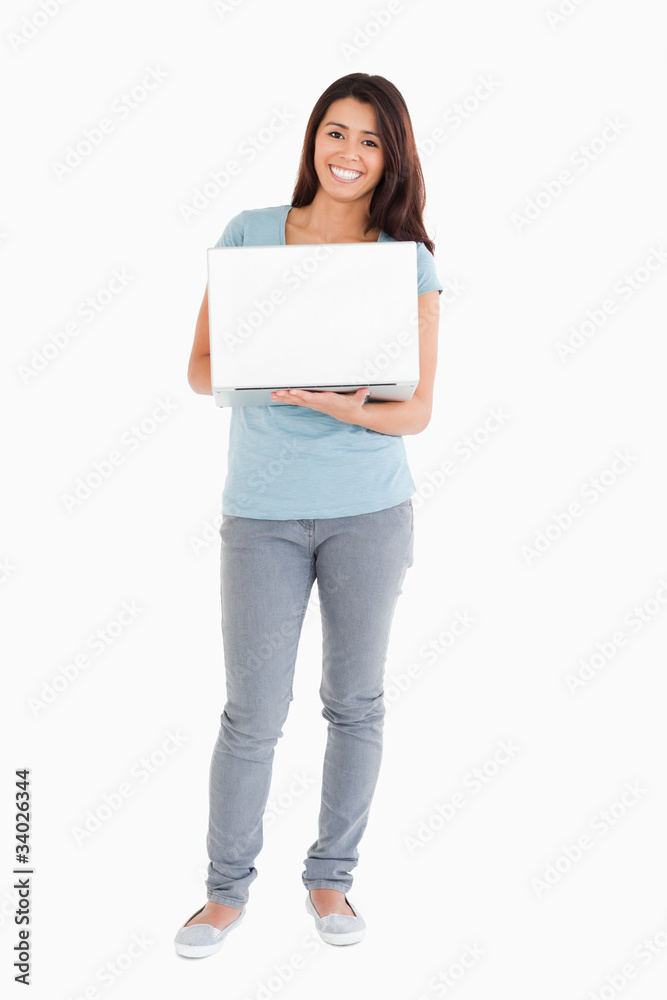 Gorgeous woman holding a laptop while posing Gorgeous woman holding a laptop while posing
