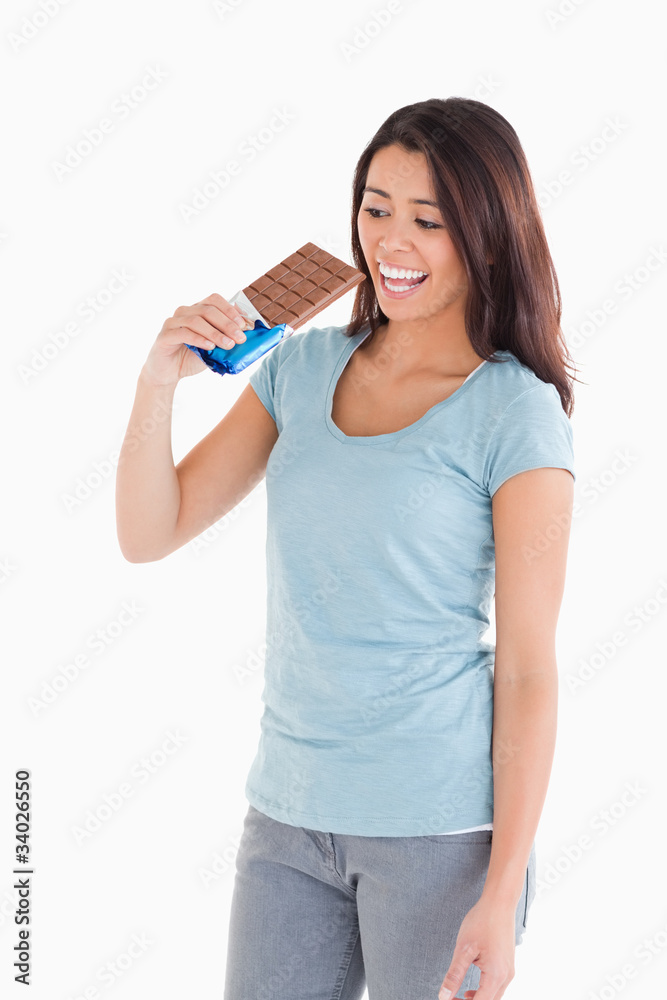 Attractive woman eating a chocolate bar Attractive woman eating a chocolate bar