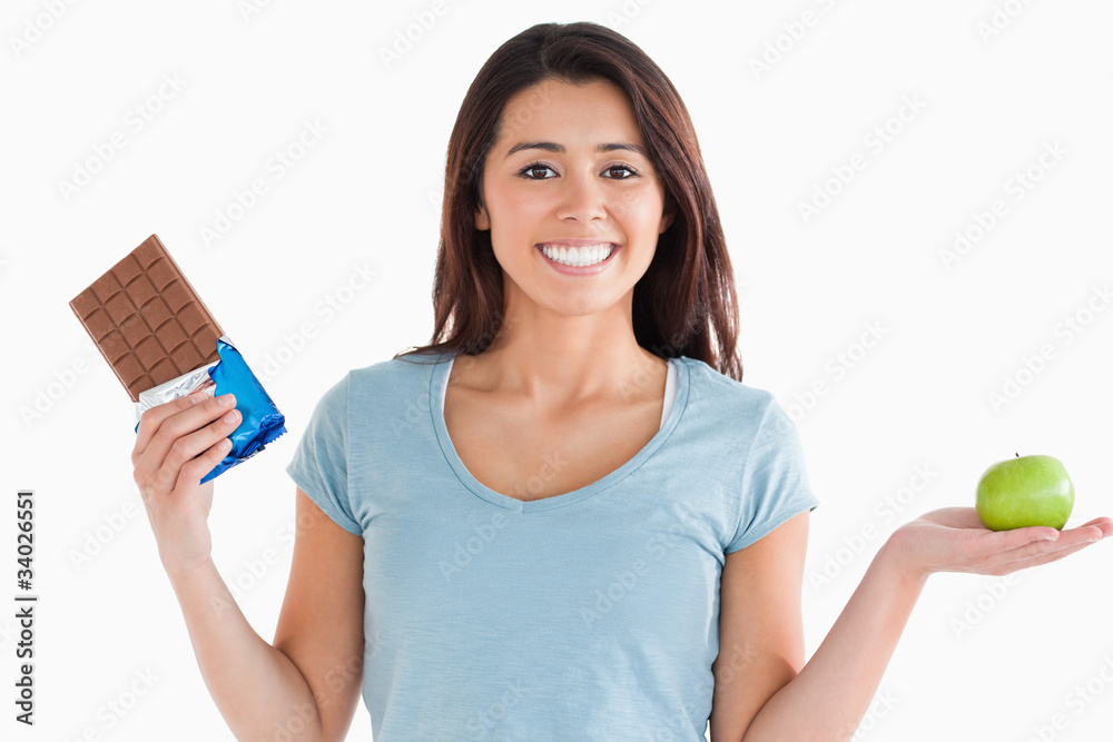 Lovely female holding a chocolate bar and an apple Lovely female holding a chocolate bar and an apple
