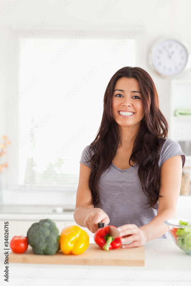 Pretty woman cooking vegetables while standing Pretty woman cooking vegetables while standing